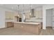 Open kitchen featuring a large center island, stainless hood, and pendant lighting at 8421 Golden Beach Ct, Parrish, FL 34219