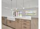 Kitchen island featuring white countertop, stylish sink and stainless appliances at 8421 Golden Beach Ct, Parrish, FL 34219