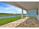 Covered patio offering peaceful water views at 8421 Golden Beach Ct, Parrish, FL 34219