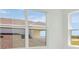 Brightly lit room with white walls and a window looking out on the neighborhood at 8421 Golden Beach Ct, Parrish, FL 34219