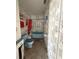 Bathroom with dated blue fixtures and floral wallpaper, needing complete renovation at 14236 Palm St, Madeira Beach, FL 33708