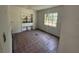 Bedroom featuring a window, built-in shelving, and old tile flooring, requiring updates at 14236 Palm St, Madeira Beach, FL 33708