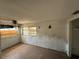 Bedroom with damaged walls, peeling paint, boarded window and worn flooring at 14236 Palm St, Madeira Beach, FL 33708
