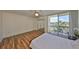 Serene bedroom featuring wood laminate floors, ceiling fan, mirrored closet, and private balcony access with outdoor seating at 2424 W Tampa Bay Blvd # B201, Tampa, FL 33607