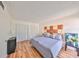 Well-lit bedroom featuring sleek laminate floors, double closets, and simple, modern furnishings for a restful ambiance at 2424 W Tampa Bay Blvd # B201, Tampa, FL 33607