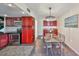 Charming dining area with modern light fixture, stylish red cabinets, and an adjacent kitchen at 2424 W Tampa Bay Blvd # B201, Tampa, FL 33607