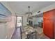Open dining area featuring stylish chandelier, tile flooring, and stainless steel refrigerator adjacent to the kitchen at 2424 W Tampa Bay Blvd # B201, Tampa, FL 33607