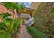 Charming condo building with lush landscaping and inviting entrance staircase for a welcoming ambiance at 2424 W Tampa Bay Blvd # B201, Tampa, FL 33607