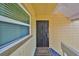 Exterior view of a secured entryway with a welcome mat and window for natural light at 2424 W Tampa Bay Blvd # B201, Tampa, FL 33607