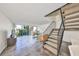 Bright living area with sliding doors to balcony and open stairway at 2424 W Tampa Bay Blvd # B201, Tampa, FL 33607