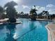 Sparkling community pool surrounded by lush landscaping and shaded lounge areas at 11616 Crest Creek Dr, Riverview, FL 33569
