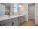 Bright bathroom featuring a double vanity with modern fixtures and a spacious walk-in closet at 11892 Richmond Trl, Parrish, FL 34219