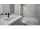 Contemporary bathroom featuring tile shower, white counter and modern fixtures at 11892 Richmond Trl, Parrish, FL 34219