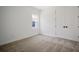Bright bedroom featuring carpet flooring, large windows, and a walk-in closet at 11892 Richmond Trl, Parrish, FL 34219