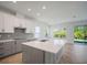Bright, spacious kitchen featuring a large island, quartz countertops, and stainless steel appliances at 11892 Richmond Trl, Parrish, FL 34219