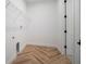 Neat laundry room with tile floors, shelving and white walls at 11892 Richmond Trl, Parrish, FL 34219