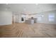 Bright living room featuring an island, light wood floors, and white walls at 11892 Richmond Trl, Parrish, FL 34219