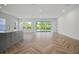 Open-concept living room featuring tile flooring, garden views, and natural light at 11892 Richmond Trl, Parrish, FL 34219