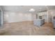 Spacious living room with a kitchen island, light wood floors, and natural light at 11892 Richmond Trl, Parrish, FL 34219