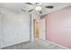 Carpeted bedroom featuring accent wall and doorway to closet at 13456 Marble Sands Ct, Hudson, FL 34669