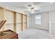 Carpeted bedroom featuring ample built-in shelving and natural light at 13456 Marble Sands Ct, Hudson, FL 34669