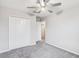 Carpeted bedroom featuring a ceiling fan, large closet and an ensuite bathroom at 13456 Marble Sands Ct, Hudson, FL 34669