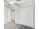 Carpeted bedroom featuring a ceiling fan and a large closet at 13456 Marble Sands Ct, Hudson, FL 34669