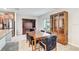 Dining area adjacent to the kitchen, featuring a wooden table, a display cabinet, and stainless steel refrigerator at 13456 Marble Sands Ct, Hudson, FL 34669