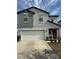 Charming two-story home showcasing a well-manicured front yard, a spacious two-car garage, and an inviting red front door at 13456 Marble Sands Ct, Hudson, FL 34669