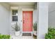 Welcoming front door entrance with potted plants and a 'Welcome Home' mat, setting a warm and inviting tone at 13456 Marble Sands Ct, Hudson, FL 34669