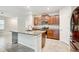 Well-lit kitchen features an island, stainless steel appliances, granite countertops, and plenty of cabinet storage at 13456 Marble Sands Ct, Hudson, FL 34669