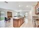 Open kitchen with granite island and sink overlooking the dining and living areas with ample natural light at 13456 Marble Sands Ct, Hudson, FL 34669