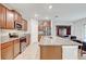 Modern kitchen featuring stainless steel appliances, granite countertops, ample cabinet space, and an island with a sink at 13456 Marble Sands Ct, Hudson, FL 34669