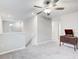 Spacious loft area with neutral carpeting and staircase at 13456 Marble Sands Ct, Hudson, FL 34669