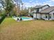 Backyard featuring pool, hot tub, patio area, and well-manicured lawn at 1492 Excaliber Dr, Clearwater, FL 33764