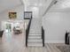 Inviting foyer showcasing a bright staircase with dark wood accents and a spacious, open floor plan at 1492 Excaliber Dr, Clearwater, FL 33764