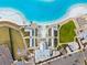 Aerial of amenity center with pool, seating and parking at the lagoon community at 17071 Oval Rum Dr, Wimauma, FL 33598