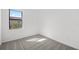 Bright bedroom features carpeted floor, a window, and neutral walls at 1975 Pepper Grass Dr, North Port, FL 34289