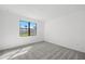 Cozy bedroom with plush carpet flooring and a large window at 1975 Pepper Grass Dr, North Port, FL 34289