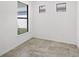 Bright room features gray tile floor and two windows at 1975 Pepper Grass Dr, North Port, FL 34289