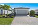 Charming single-Gathering home with a well-manicured lawn, paved driveway, and attached two-car garage at 1975 Pepper Grass Dr, North Port, FL 34289