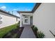 Inviting front entrance with a stone-paved walkway, neat landscaping, and a stylish front door at 1975 Pepper Grass Dr, North Port, FL 34289
