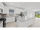 Modern kitchen with stainless steel appliances, granite countertops, and large kitchen island at 1975 Pepper Grass Dr, North Port, FL 34289