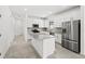 Modern kitchen features white cabinets, stainless steel appliances, and a granite countertop island at 1975 Pepper Grass Dr, North Port, FL 34289