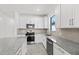 Well-equipped kitchen featuring granite countertops, stainless steel appliances, and ample cabinet space at 1975 Pepper Grass Dr, North Port, FL 34289