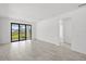 Tiled living room with a sliding glass door leading to the backyard at 1975 Pepper Grass Dr, North Port, FL 34289