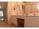 Bathroom featuring a double sink vanity with tile floors, and framed mirror at 35324 Whispering Pines Dr, Zephyrhills, FL 33541