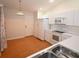 Well-lit kitchen featuring white appliances and a stainless steel sink at 35324 Whispering Pines Dr, Zephyrhills, FL 33541