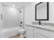 Bathroom featuring white vanity, granite countertop, and a tub shower with white tile at 4743 Michaler St, North Port, FL 34286