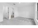 Bright bedroom with ensuite bathroom featuring plush grey carpet and white walls at 4743 Michaler St, North Port, FL 34286
